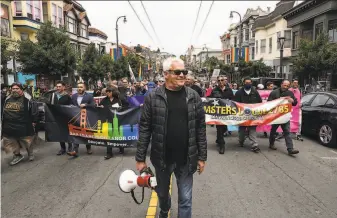  ?? Photos by Yalonda M. James / The Chronicle ?? Cleve Jones leads a march on Castro Street to the home of Allan Baird, who gave slain LGBTQ rights icon Harvey Milk his muchused bullhorn. The march honored Baird for his activism.