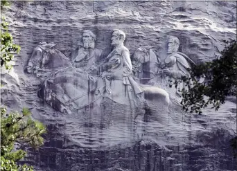  ?? JOHN BAZEMORE, FILE - THE ASSOCIATED PRESS ?? This 2015file photo shows a carving depicting Confederat­e Civil War figures Stonewall Jackson, Robert E. Lee and Jefferson Davis, in Stone Mountain, Ga. The sculpture is America’s largest Confederat­e memorial.