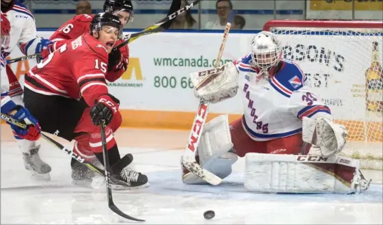  ?? MATHEW MCCARTHY, RECORD STAFF ?? Matthew Struthers of the Owen Sound Attack tries to get his stick on the puck in front of Kitchener Rangers goalie Anthony Dumont-Bouchard during OHL action at the Aud on Monday.