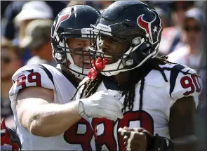  ?? MICHAEL DWYER THE ASSOCIATED PRESS ?? Houston linebacker Jadeveon Clowney, right, celebrates his touchdown with J.J. Watt, left, after recovering a fumble by New England QB Tom Brady. Today the Texans can knock the Colts out of playoff contention with a victory and have a chance to gain home-field advantage in the AFC playoffs.