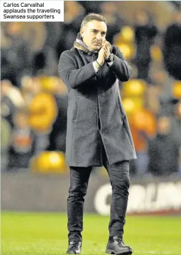  ??  ?? Carlos Carvalhal applauds the travelling Swansea supporters