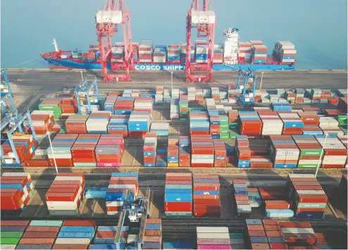  ?? STR / AFP VIA GETTY IMAGES FILES ?? Shipping empty containers — like these stacked at a port in Lianyungan­g in China’s eastern Jiangsu province — back
to China has resulted in a global competitio­n to get food to where it needs to be along with higher freight costs.