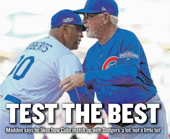  ?? | ALEX TRAUTWIG/ GETTY IMAGES ?? Managers Dave Roberts of the Dodgers and Joe Maddon of the Cubs shake hands during the National League Championsh­ip Series last season.