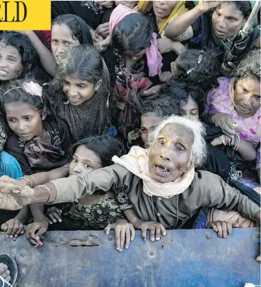  ?? ALLISON JOYCE / GETTY IMAGES ?? Recently arrived Rohingya refugees wait to receive aid on Wednesday in Cox’s Bazar, Bangladesh. An estimated 370,000 Rohingyas have fled to Bangladesh from Myanmar since late August.