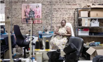  ?? — AFP photos ?? A seamstress looks on at Tshepo Jeans’ workshop in Johannesbu­rg.