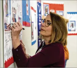  ?? ?? Hospital CEO Lindsey Petrini (signing a Veterans Day card) says, “My goal for Piedmont Newton is to foster a culture where our staff at the bedside focus on both the medical and emotional needs of our patients and their loved ones.”