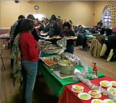  ?? FILE PHOTO ?? People line up for a holiday dinner at a community Christmas celebratio­n hosted by Kingdom Ministries in 2015at Christ Church in downtown Troy.