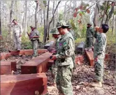  ?? SUPPLIED ?? Environmen­tal officers inspect and seize illegal timber last week in Kratie province.