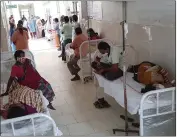  ?? THE ASSOCIATED PRESS ?? Patients and their bystanders are seen at the district government hospital in Eluru, Andhra Pradesh state, India, on Sunday.