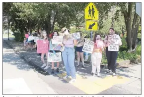  ?? (NWA Democrat-Gazette/Lynn Kutter) ?? A group of teenagers, adults and a child stand at Mock Park in Prairie Grove last week, peacefully supporting the Black Lives Matter movement. The protest was organized through an Instragram post.