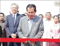  ?? FACEBOOK ?? Prime Minister Hun Sen inaugurate­s a new Japan-funded bridge Tuesday as Ambassador Hidehisa Horinouchi looks on.