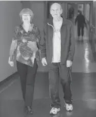  ?? CHRIS MIKULA / OTTAWA CITIZEN ?? Emil Lokar and his wife, Marianna Pilat, go for a walk in the halls of the Civic campus of the Ottawa Hospital as part of a program to get folks out of bed regularly and keep moving.