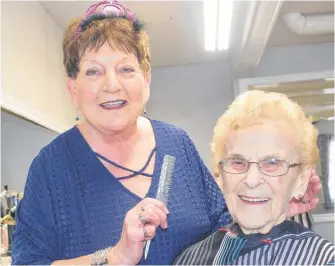  ?? SHARON MONTGOMERY-DUPE • CAPE BRETON POST ?? Joan Mackinnon, 72, a hairdresse­r for 53 years and owner of the Isle Royal Beauty Salon in Sydney, styles the hair of Lillian Macivor, 98, a loyal client for more than 50 years. Mackinnon celebrated her last day at work Friday.