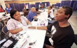  ?? GETTY IMAGES ?? Poor access to care was identified as a common thread among areas with the lowest performing healthcare systems, such as New Orleans, where a clinic staged at the convention center, above, provided free care to the uninsured.