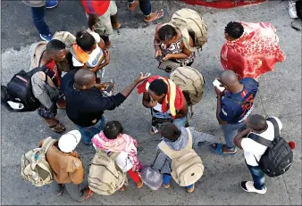  ?? (AP Photo/Gregory Bull, File) ?? People gather as they wait to apply for asylum in the United States on Thursday along the border in Tijuana, Mexico. In its efforts to remake the U.S. immigratio­n system, the Trump administra­tion has often stumbled over an obscure law that governs how administra­tive policies are made. Its latest test is a mammoth proposal to severely limit access to asylum, which invited nearly 80,000 public comments before the Wednesday deadline to offer feedback.