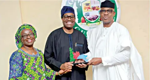  ??  ?? Ogun State Governor, Prince Dapo Abiodun, presenting a souvenir making the 20 Local Councils in the State to the President of Africa Developmen­t Bank (AFDB), Dr Akinwunmi Adesina and wife, Yemisi in Abeokuta…yesterday