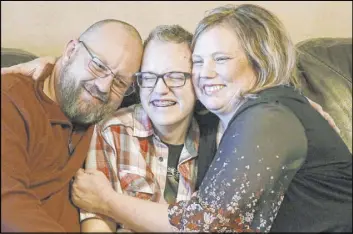  ?? Rick Bowmer The Associated Press ?? Dex Rumsey, 15, shown here with parents Clay and Robyn on Friday in Roy, Utah, came out as transgende­r at 12. He’s scared he could become suicidal again if a ban on hormone therapy and sex-reassignme­nt surgery for minors were to pass.
