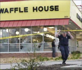  ?? GEORGE WALKER IV — THE TENNESSEAN VIA AP ?? Law enforcemen­t officials work the scene of a fatal shooting at a Waffle House in the Antioch neighborho­od of Nashville, Sunday.