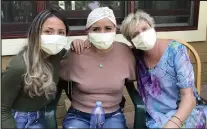  ?? Courtesy photo ?? Eloisa Heyward, center, who is battling stage four breast cancer, sits with her daughter Geraldine Albornoz. left, and friend and former colleague Diana Weekely.