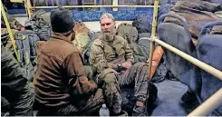  ?? | Reuters ?? SERVICE members of Ukrainian forces who have surrendere­d after weeks holed up at Azovstal steel works sit inside a bus that arrived under escort of the pro-Russian military at a detention facility in Olenivka in the Donetsk Region.