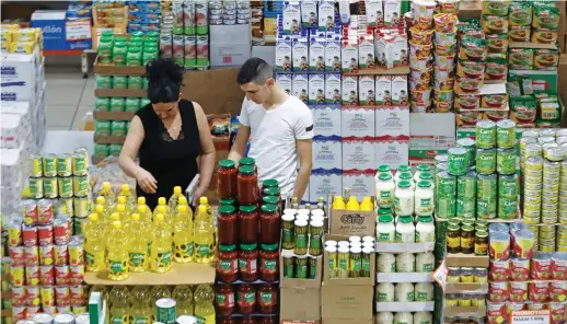  ?? AFP ?? Customers at a supermarke­t in the wake of an economic crisis in the Lebanese capital Beirut. Many Lebanese have been forced to close shop, and a large number have been fired or seen their salaries slashed by half, even as the cost of living increases.