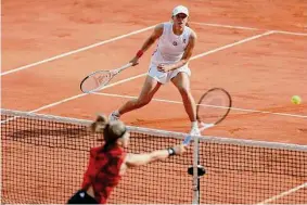  ?? Jean-Francois Badias/Associated Press ?? Iga Swiatek watches as Karolina Muchova, foreground, plays a shot during the women's final match of the French Open on Saturday in Paris.