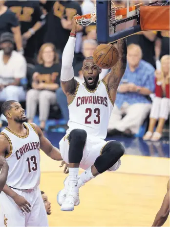  ?? RON SCHWANE/ASSOCIATED PRESS ?? Cavaliers forward LeBron James (23) dunks against the Golden State Warriors during the first half of Thursday night’s Game 6 of the NBA Finals in Cleveland. The Cavs won to force a winner-take-all Game 7.