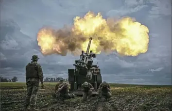  ?? Aris Messinis/AFP via Getty Images ?? Ukrainian servicemen fire with a French self-propelled 155 mm/52-calibre gun toward Russian positions Wednesday at a front line in the eastern Ukrainian region of Donbas.