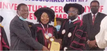  ??  ?? Dr. Mrs. Modupe Adeleke- Sanni flanked on the left Vice - chancellor Adeleke University, Ede, Osun State, and the Registrar, Africa Institute of Public Health Profession­als, during her investitur­e as a Fellow of the Institute, at a ceremony held at Adeleke University, Ede.