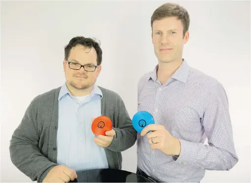  ?? MARK YUEN ?? Trent Shumay, left, and Graham Cunliffe of IoT Design Shop with their Signul personal beacon system which includes small, battery- powered beacons and a smartphone app that enables you to automate many routine tasks like unlocking a door, turning...