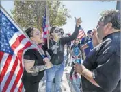  ?? Irfan Khan Los Angeles Times ?? ANTI-SHARIA demonstrat­ors, left, debate an antifascis­t counter-demonstrat­or Saturday near the site of the 2015 San Bernardino terrorist massacre.