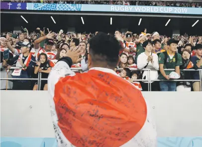  ?? Picture: AFP ?? SO PROUD. Japanese centre Timothy Lafaele is draped in a Japanese flag after they were knocked out of the Rugby World Cup by the Springboks in the quarterfin­als.