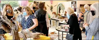  ?? (NWA Democrat-Gazette/March Hayot) ?? Customers crowd in Amy Haid Studio to look at the art for sale during the Sept. 10 Girls Night Out. Main Street Siloam Springs hosts the quarterly event to encourage residents and visitors to come and shop at downtown businesses.