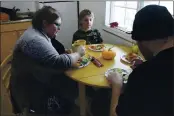  ?? MARK THIESSEN — THE ASSOCIATED PRESS ?? Airis Messick, left, and Brian Messick, right, eat lunch with this 9-year-old son, Jayden, at their apartment in Anchorage, Alaska, on Wednesday Nov. 11. Messick and her husband have had to turn to food banks after both lost their jobs in the economic downturn caused by the coronaviru­s pandemic. Airris, who just turned 30, found work in August, ironically, at the state unemployme­nt office. “I hear people’s stories all day,” she says. “I listen to moms cry about not having money to take care of their kids. My heart aches for the people who get denied.”