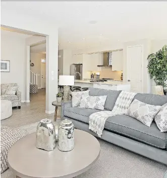  ??  ?? The great room in the Stirling show home features a horizontal fireplace low on the wall with a television above.