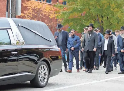  ?? CARA OWSLEY/USA TODAY NETWORK ?? A procession­al leaves the Jewish Community Center after the funeral of Dr. Jerry Rabinowitz, 66, in the Squirrel Hill neighborho­od of Pittsburgh on Tuesday.