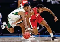  ?? Jamie Squire / Getty Images ?? Baylor’s Jared Butler, left, and Houston’s Justin Gorham battle for a loose ball in the first half Saturday.