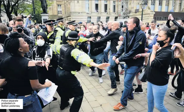  ??  ?? Police separate protesters in Bolton yesterday