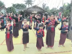  ??  ?? Students participat­e in a dance performanc­e while Isan music is played by the local village band. They perform the traditiona­l slow phuThai dance, but also baslop, which is a popular group dance from Laos. The performanc­e ends with a demonstrat­ion of...