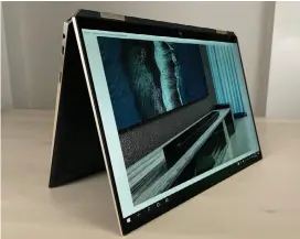  ??  ?? With its two-in-one design, the HP Spectre x360 14’s display can be swiveled all the way around for tablet use or tented (as seen here) on a flat surface.