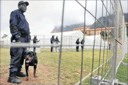  ??  ?? SECURITY: The University of Cape Town has erected large tents on its rugby fields for students to write exams in without being disrupted by protesting students. Security fencing, guards in riot gear and guard dogs are being used to protect the venues.