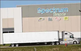  ?? CORNELIUS FROLIK / STAFF ?? A semi-trailer drives past the Spectrum Brands facility at the Dayton Internatio­nal Airport. Spectrum is one of the leading driver of jobs at the airport.