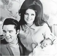  ?? AP ?? Elvis Presley is shown on Feb. 5, 1968 , with his wife Priscilla and their newly born daughter, Lisa Marie.