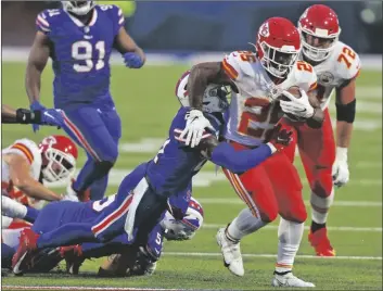  ?? ASSOCIATED PRESS ?? KANSAS CITY CHIEFS RUNNING BACK CLYDE EDWARDS-HELAIRE (right) runs the ball during the first half of a game against the Buffalo Bills on Monday, in Orchard Park, N.Y.