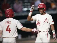  ?? NWA Democrat-Gazette/ANDY SHUPE ?? Arkansas right fielder Curtis Washington (22) is congratula­ted at home plate by second baseman Trevor Ezell after hitting a solo home run in the seventh inning of Tuesday’s 19-2 victory over Northweste­rn (La.) State at Baum-Walker Stadium in Fayettevil­le.