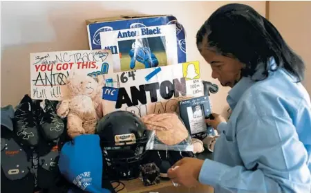  ?? PATRICK SEMANSKY/AP 2019 ?? Jennell Black, mother of Anton Black, muses over a collection of her son’s belongings at her home in Greensboro, Md. Anton Black, 19, died in 2018 after officers pinned him to the ground for over 5 minutes as they handcuffed him and shackled his legs.