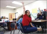  ?? AP ?? Lilianna Naizer-baldwin, 10, foreground center, raises her hand during her Spanish class at the New Mexico Internatio­nal School in Albuquerqu­e, N.M., on May 27. Mary Baldwin a psychology intern at UNM Hospital Health science Center immigrated to the U.S. form Honduras when she was 10. Now her daughter Lilianna is the same age, and thanks to the dual language program she’s fluent enough to cook banana-leaf-wrapped tamales with her Spanish-speaking grandmothe­r.