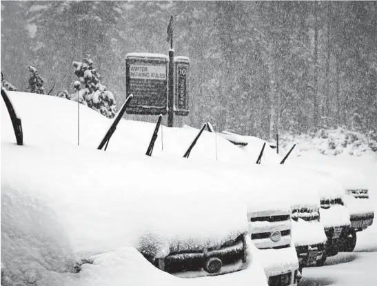  ?? CHRISTIAN PONDELLA/MAMMOTH MOUNTAIN SKI AREA ?? Falling snow collects on cars in a parking lot Oct. 25, 2021, at Mammoth Mountain in Mammoth Lakes, California.