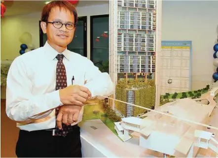  ??  ?? High-end condo: Johan with a model of the upcoming TTDI Ascencia condominiu­m developmen­t in TTDI.