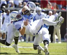 ?? THOMAS GRANING — THE ASSOCIATED PRESS ?? Mississipp­i safety AJ Finley, left, and linebacker Austin Keys force a fumble by Kentucky quarterbac­k Will Levis during Saturday's game.